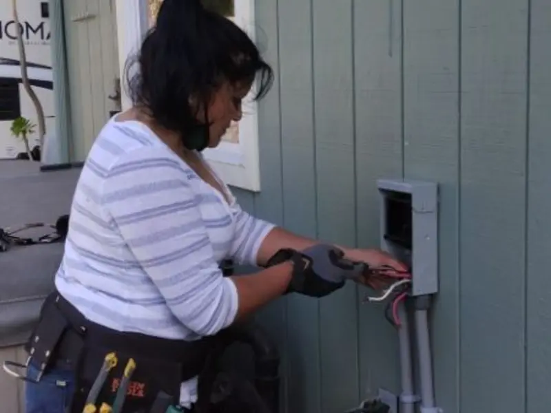 Licensed electrician wiring an exterior subpanel in Hubbard